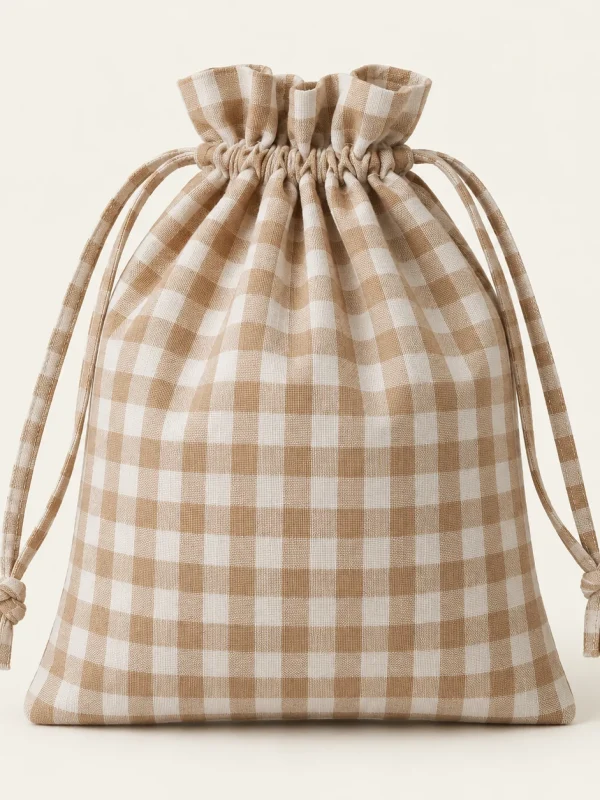 Gingham Drawstring Bag on a warm ivory background — AI-generated design illustration